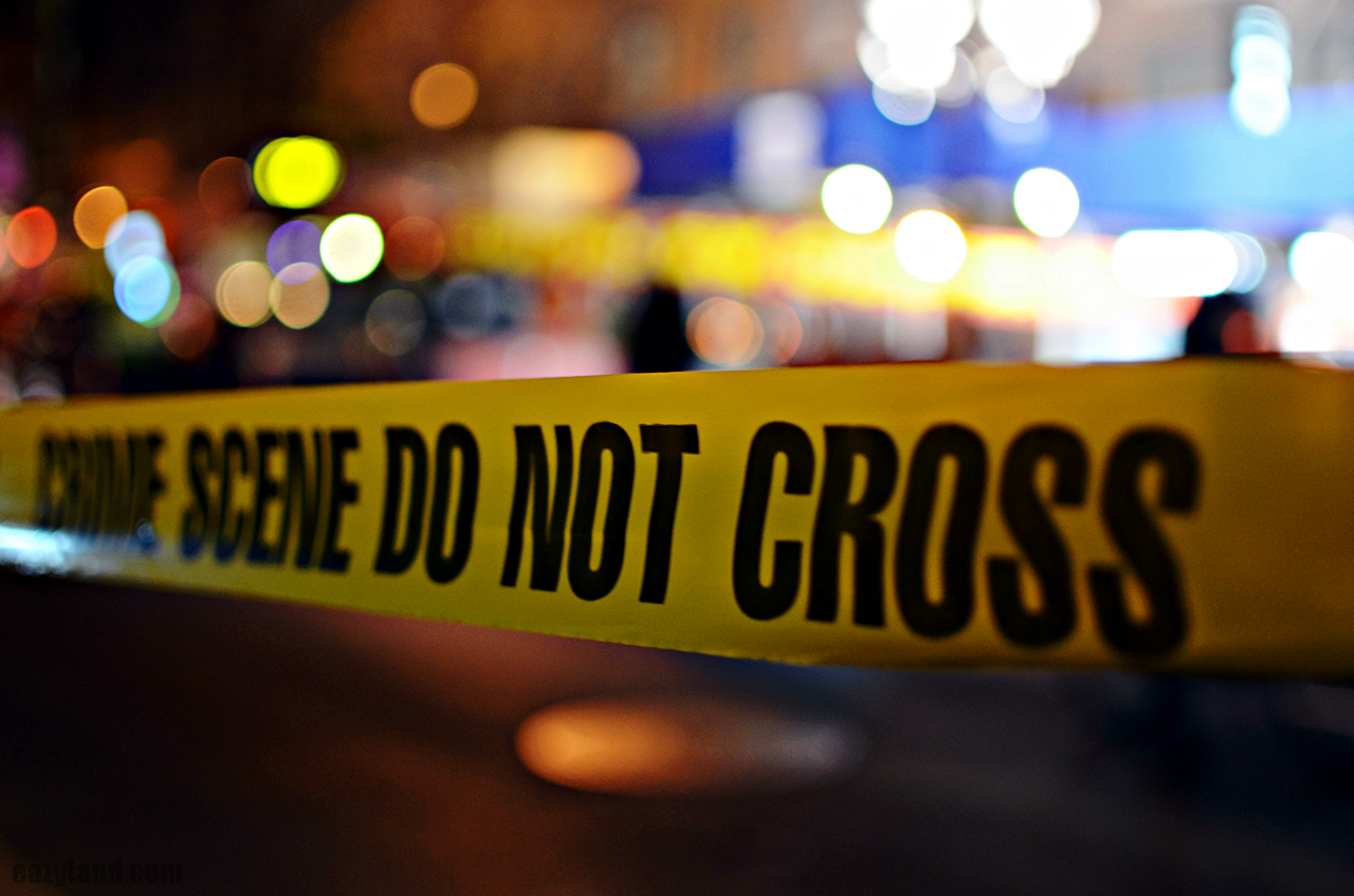 photo of crime scene tape and lights at night