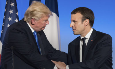 Image of President Donald Trump and French President Emmanuel Macron shaking hands.