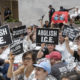 AP photo of activists carrying "Abolish I.C.E." signs