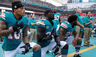 Photo of Miami Dolphins kneeling during the National Anthem before NFL game