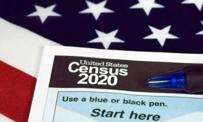 Photo illustration of American flag and 2020 census form