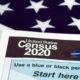 Photo illustration of American flag and 2020 census form