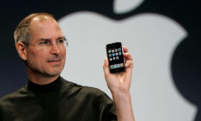 Photo of Steve Jobs holding up iPhone