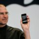 Photo of Steve Jobs holding up iPhone