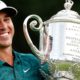 Photo of Brooks Koepka holding the Wanamaker Trophy