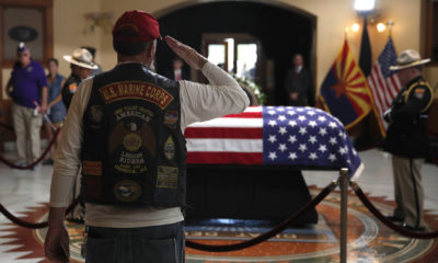 Photo of retired Marine saluting the casket of John McCain