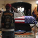 Photo of retired Marine saluting the casket of John McCain