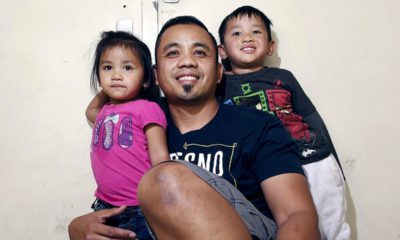 Photo of pardoned minister Vanna In and two of his children