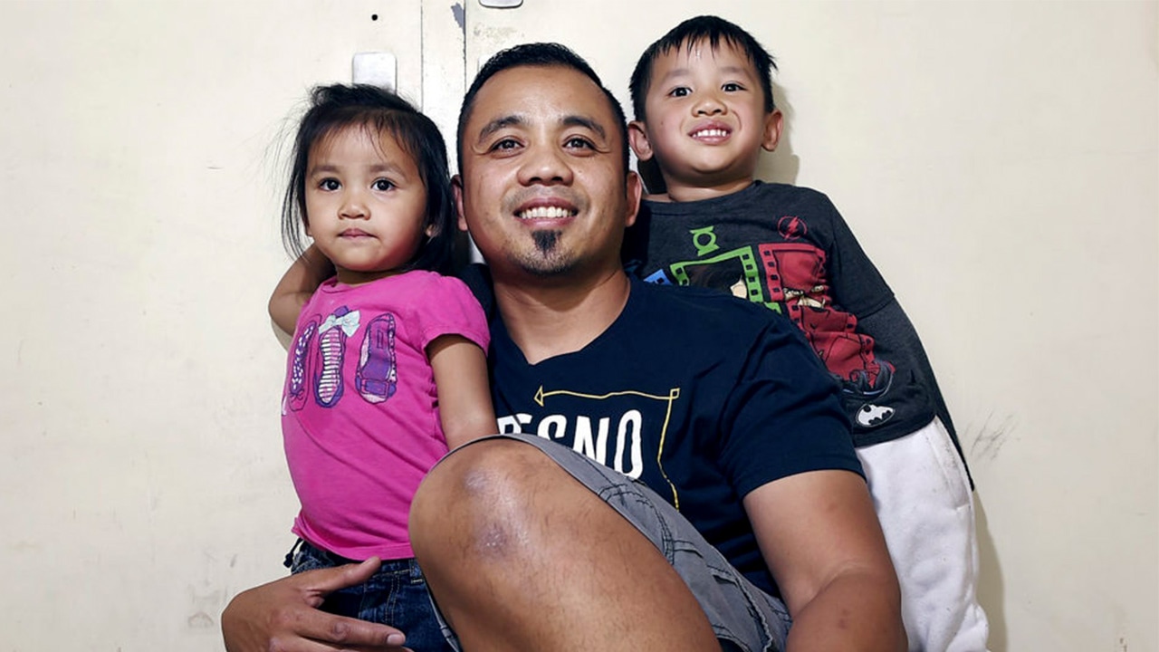 Photo of pardoned minister Vanna In and two of his children