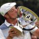 Photo of Bryson DeChambeau kissing the trophy after winning the Northern Trust golf tournament