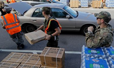 Photo of members of the Civil Air Patrol loading cars with MREs, water and tarps