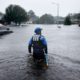 Photo of a member of the North Carolina Task Force search and rescue team wading through flooded neighborhoods