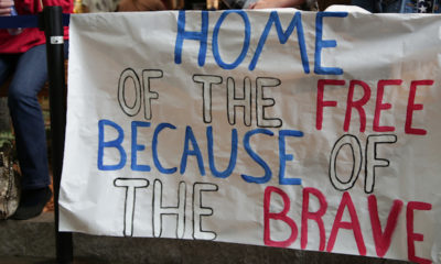 Supporters hold signs welcoming veterans home from the 17th Central California Honor Flight.