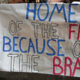 Supporters hold signs welcoming veterans home from the 17th Central California Honor Flight.