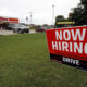 Photo of a "Now Hiring" sign in English and Spanish