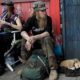 Photo of Stormy Nichole Day, Nord, and dog Hobo sitting on the street in San Francisco