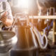 Photo of raw milk being poured into a stainless steel container