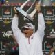 Photo of Fresno State football coach Jeff Tedford holding the trophy