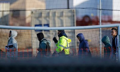 Photo of teen migrants walking in a line