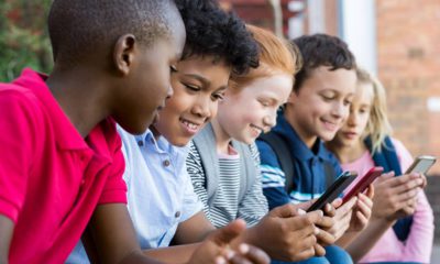 Photo of children on their cell phones