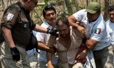 Photo of a Central American migrant being detained by Mexican immigration agents in Mexico