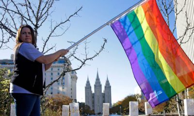 Photo of a woman holding a rainbow flag