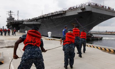 Photo of Navy shore crew hauling in lines