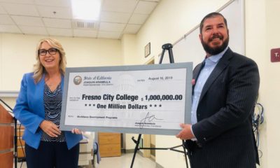 Photo of Carole Goldsmith and Assemblyman Joaquin Arambula holding a check