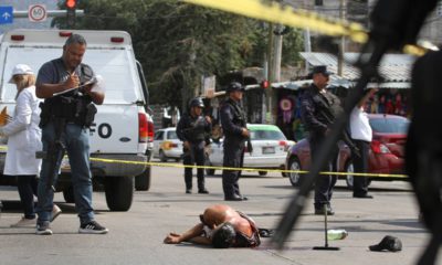 Photo of a bloodied man laying in the street in Mexico