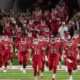 Photo of Fresno State football players running onto the field at Bulldog Stadium