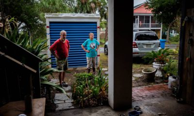 Photo of couple standing outside their home before evacuating