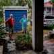 Photo of couple standing outside their home before evacuating