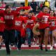 Photo of Fresno State students running onto the football field