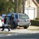 Photo of Fresno police investigators working in the driveway