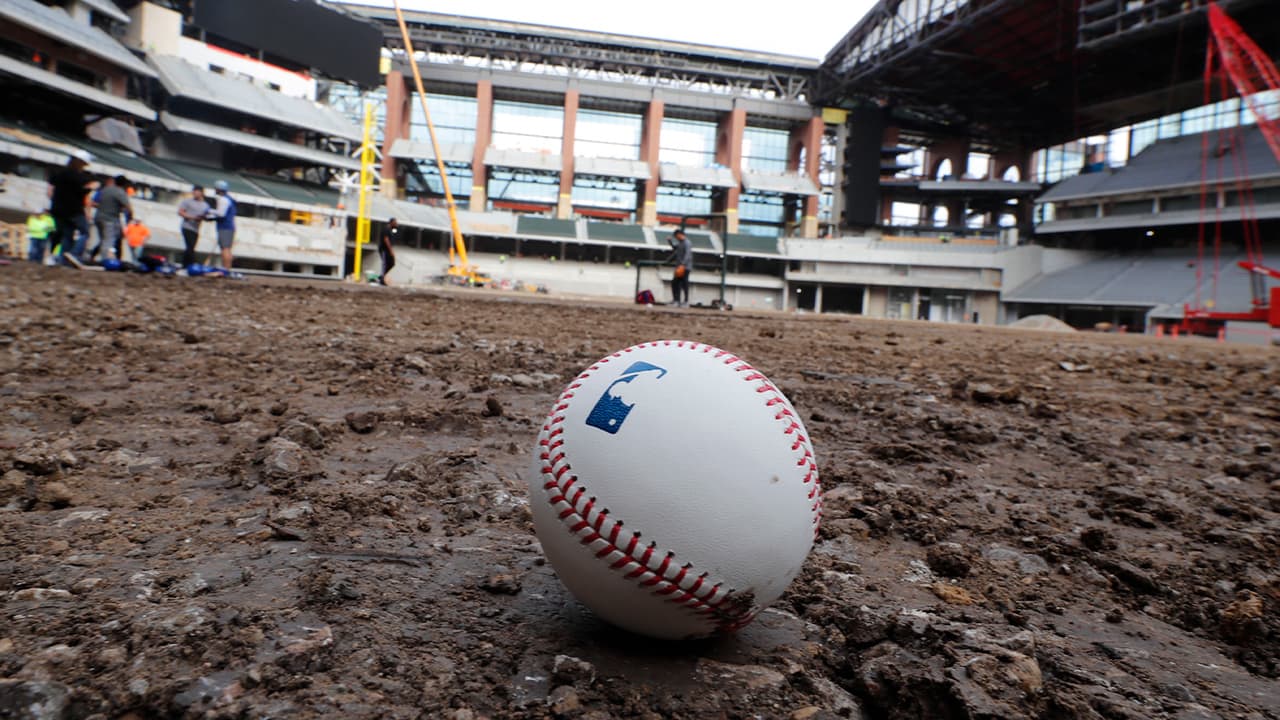 Photo of a baseball on packed dirt