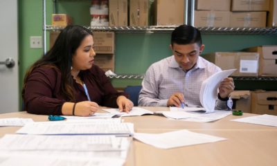 Photo of 2 people filling out detainer forms during a housing clinic