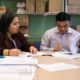 Photo of 2 people filling out detainer forms during a housing clinic