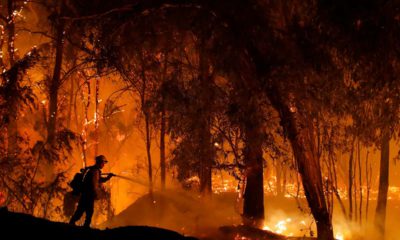 Photo of firefighter battling a wildfire in California