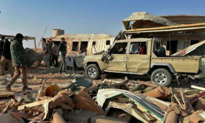 Photo of fighters from the Kataeb Hezbollah, or Hezbollah Brigades militia inspecting destruction