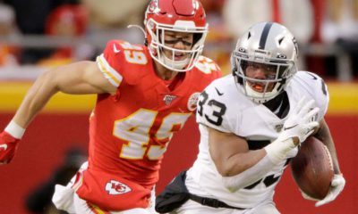 Photo of Oakland Raiders running back DeAndré Washington running away from Kansas City Chiefs safety Daniel Sorensen