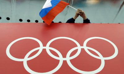 Photo of a Russian skating fan holding the country's flag