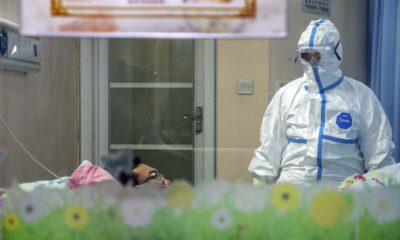 Photo of a doctor with to a patient in an isolation ward at a hospital in Wuhan in central China's Hubei Province