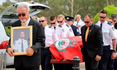 Photo of New South Wales Rural Fire Service crew members from Horsley Park RFS carrying the casket of Andrew O'Dwyer