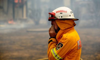 Photo of a firefighter covering his face