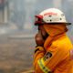 Photo of a firefighter covering his face