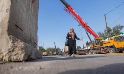 Photo of a woman passing by Iraqi security forces