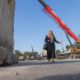 Photo of a woman passing by Iraqi security forces