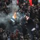 Photo of mourners burning mock flags of the U.S. and Israel during a funeral ceremony for Iranian Gen. Qassem Soleimani