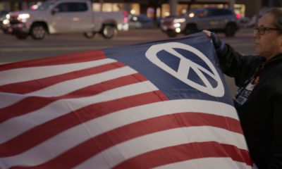 Photo of an American flag with a peace symbol