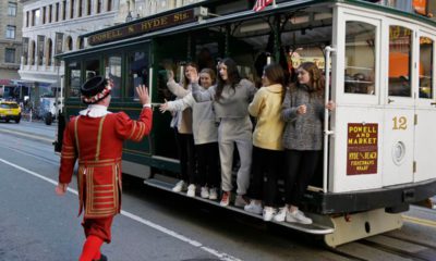 Photo of Tom Sweeney greeting trolly riders in San Francisco